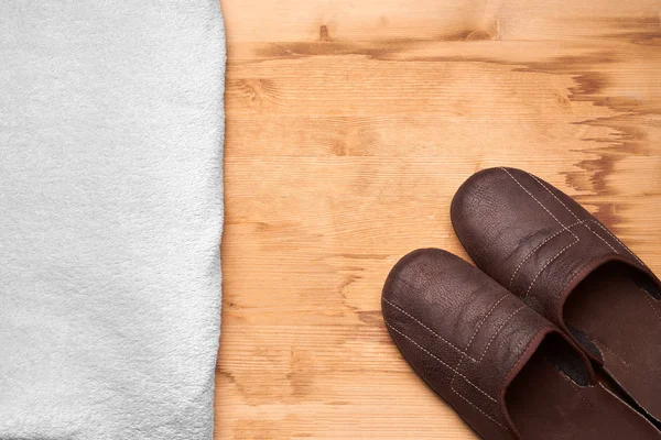 Men's slippers on the wooden table — Stock Photo, Image