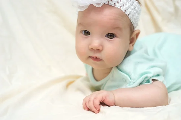 Happy baby lying on his stomach — Stock Photo, Image