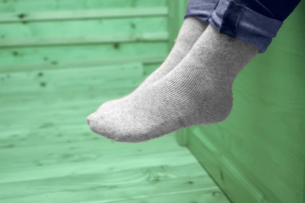 Female legs in woolen socks — Stock Photo, Image