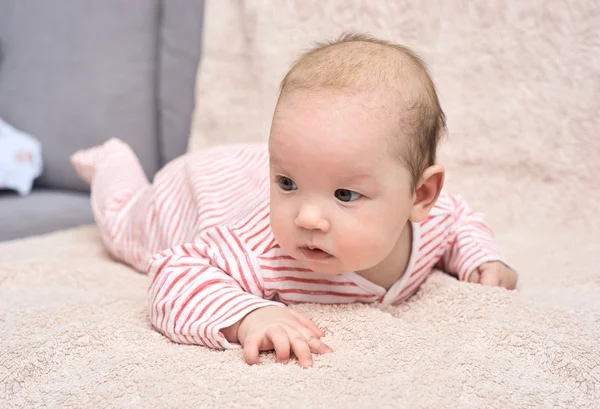 Happy baby lying on his stomach — Stock Photo, Image