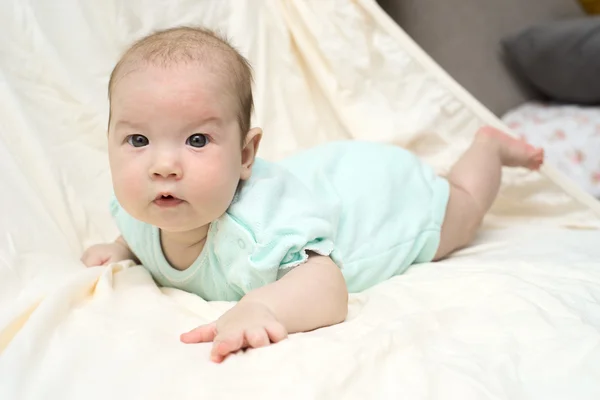 Happy baby lying on his stomach — Stock Photo, Image