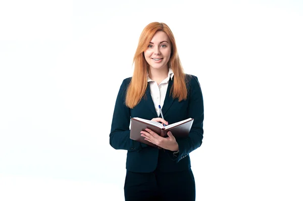 Schöne Geschäftsfrau, die ein Tagebuch führt — Stockfoto