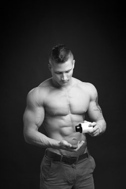 Strong bodybuilder uses nutritional supplements