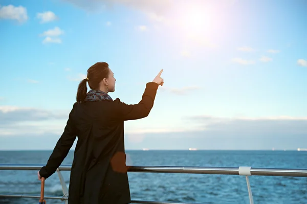 beautiful woman pointing at the sky