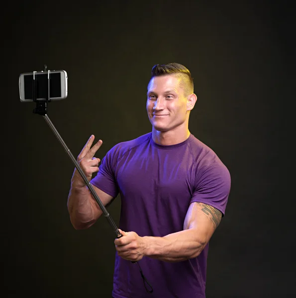 Happy man photographing himself on the phone — Stock Photo, Image