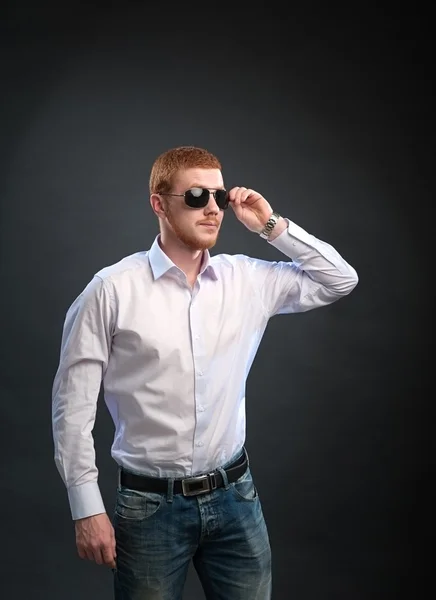 Een bebaarde man in een shirt en zonnebril — Stockfoto