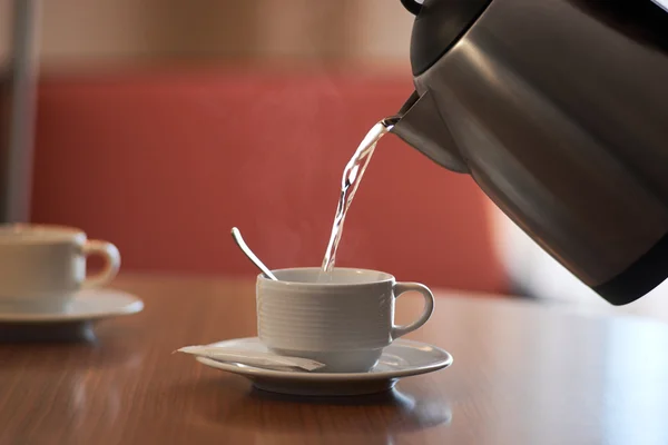 Pour boiling water from the kettle into the cup — Stock Photo, Image