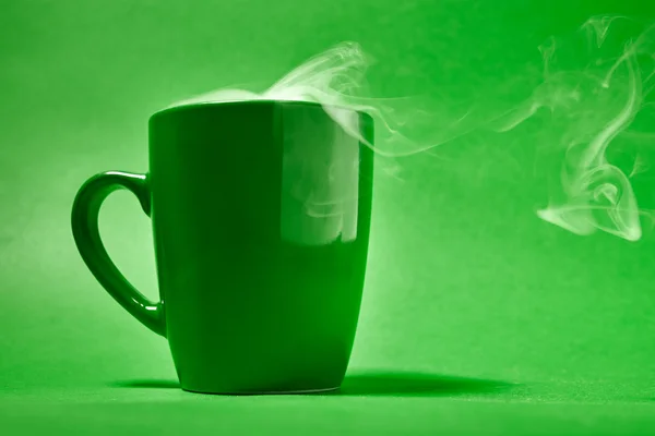 Cup of coffee on a green background — Stock Photo, Image