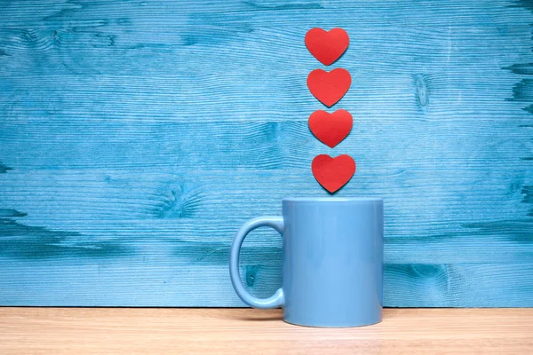 Heart and cup on a blue background — Stock Photo, Image