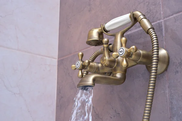 Modern water tap in the bathroom. Flowing water. — Stock Photo, Image