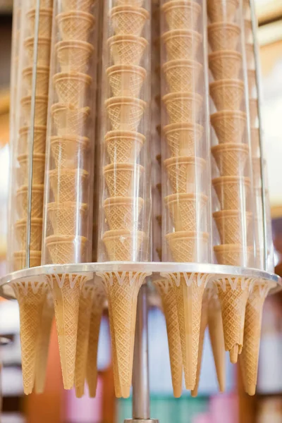 Empty wafer ice cream cones on stand. Ice cream store