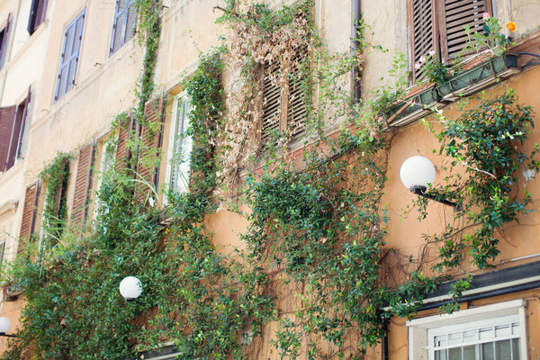 Facade of old house in Rome, Italy. Beautiful house with old walls