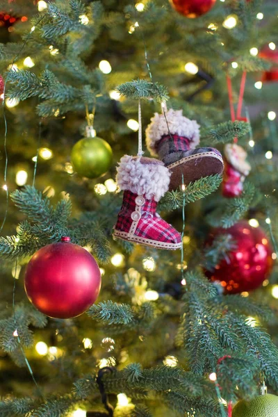 Christmas tree with red and green decorations and cozy Christmas lights. Background of Christmas tree