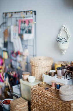 Eski eşyaların, hasır sepetlerin ve iplikli kutuların olduğu yaratıcı bir iş yeri.