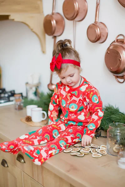 Little Girl Red Pajamas Sitting Table Christmas Kitchen Christmas Decorations — Stock Photo, Image