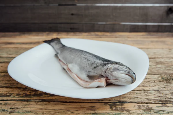 Fresh fish on wooden table — Stock Photo, Image