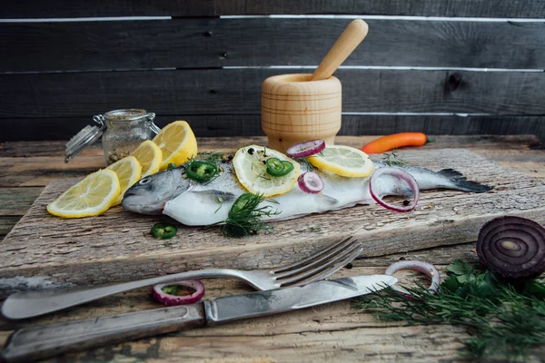 Fresh fish on wooden table — Stock Photo, Image