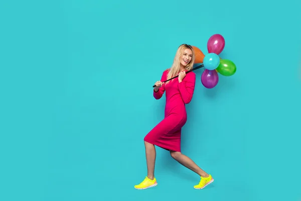 Blonde woman with balloons on blue — Stock Photo, Image