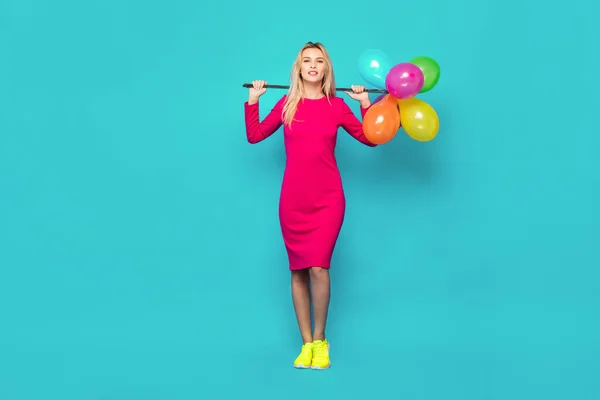 Blonde woman with balloons on blue — Stock Photo, Image