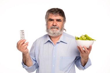 yaşlı adam hapları ve salata ile