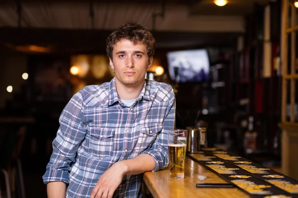 一人の男がビールを持ってバーに座って — ストック写真