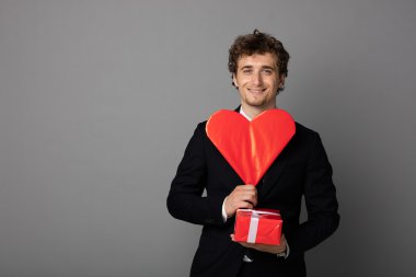 bir kalp elinde tutan shuit yakışıklı adam