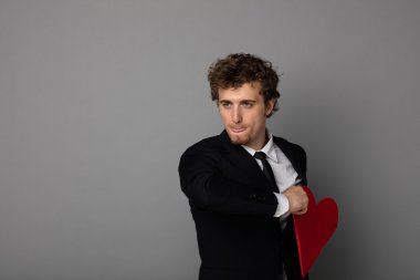 bir kalp elinde tutan shuit yakışıklı adam