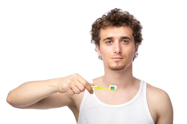 Curly guy brushing his teeth — Stock Photo, Image