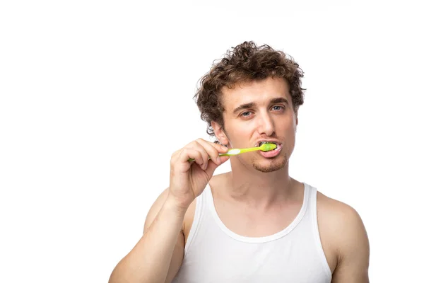 Curly guy brushing his teeth — Stock Photo, Image