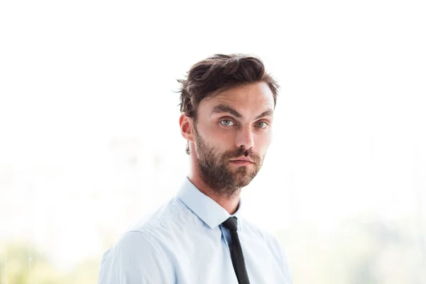 Businessman standing next to a big window — Stock Photo, Image