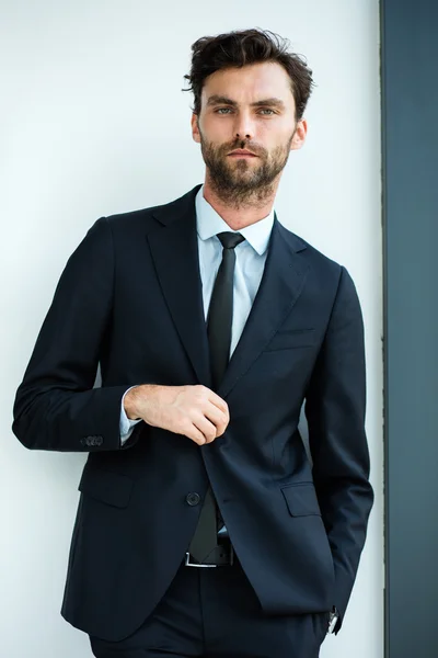 Businessman standing next to a big window — Stock Photo, Image