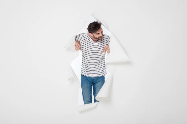 Casual man breaking the paper background — Stock Photo, Image