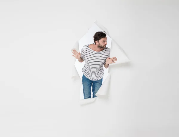 Casual man breaking the paper background — Stock Photo, Image