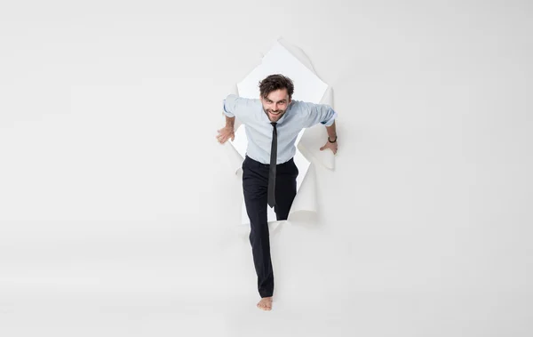 Office man with elegant outfit and tie breaking the paper backgr — Stock Photo, Image