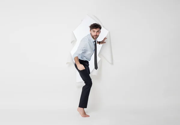 Office man with elegant outfit and tie breaking the paper backgr — Stock Photo, Image