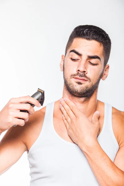 Young handsome man trimming his beard — Stock Photo, Image
