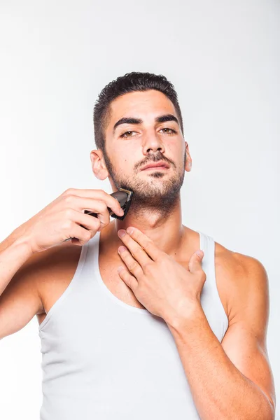 Jovem bonito homem aparando sua barba — Fotografia de Stock