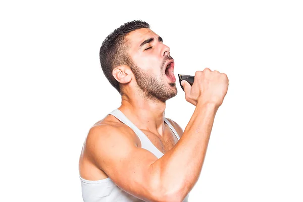 Junger schöner Mann singt an seinem Trimmer — Stockfoto