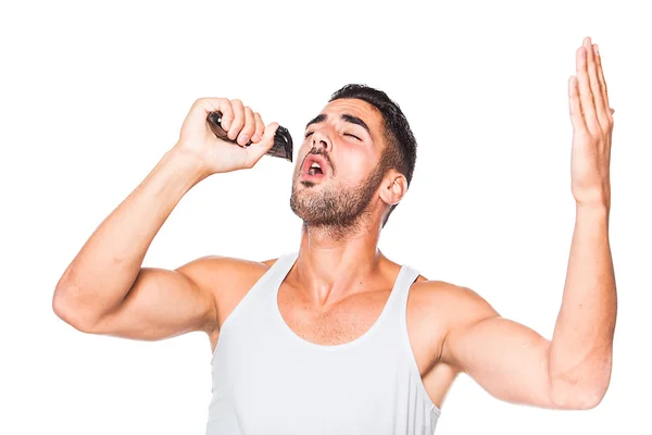 Young handsome man singing at his trimmer — Stock Photo, Image
