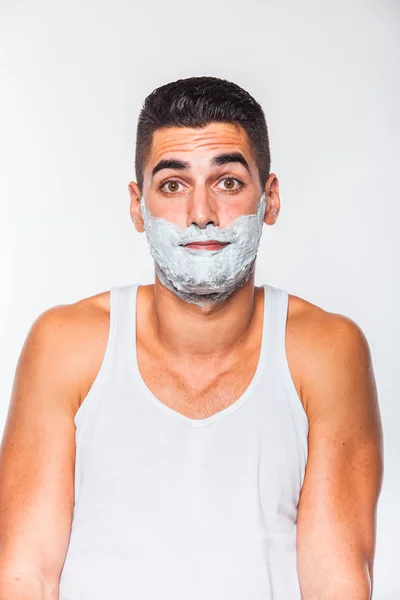 Homem bonito com creme de barbear — Fotografia de Stock