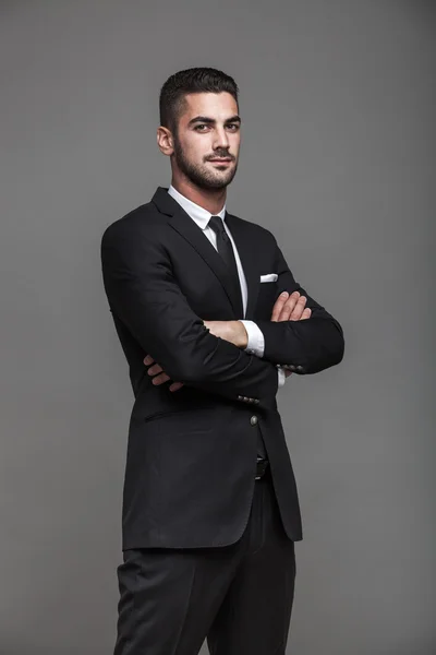 Hombre elegante guapo sobre fondo gris —  Fotos de Stock