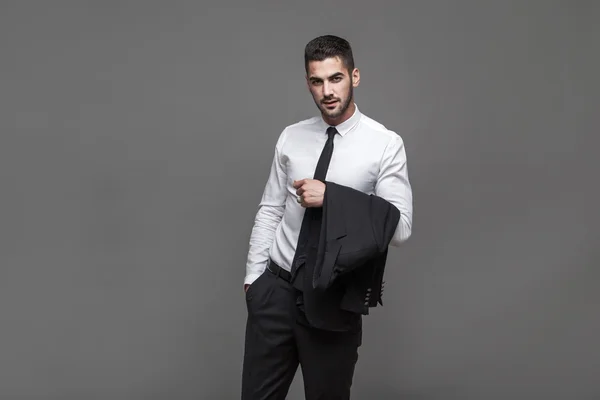 Hombre elegante guapo sobre fondo gris — Foto de Stock