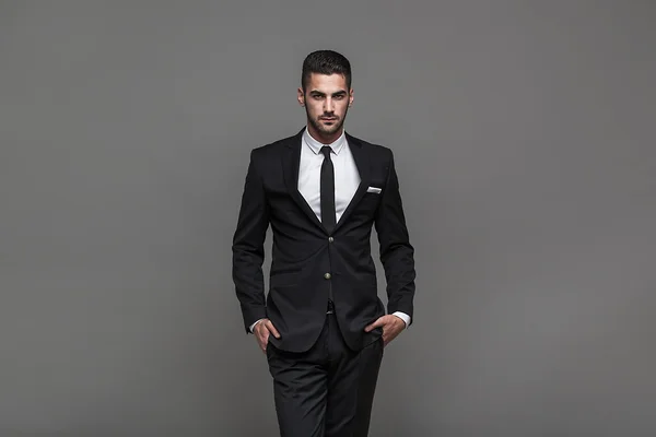 Handsome elegant man on grey background — Stock Photo, Image