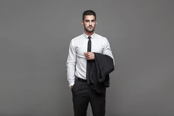 Hombre elegante guapo sobre fondo gris — Foto de Stock