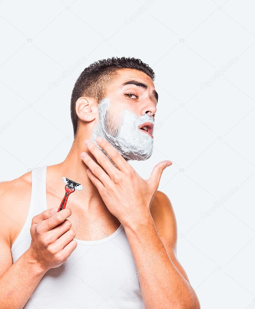 handsome man shaving his beard
