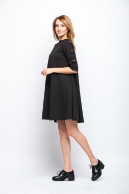 gri arka plan üzerinde duran güzel genç sarışın kadın