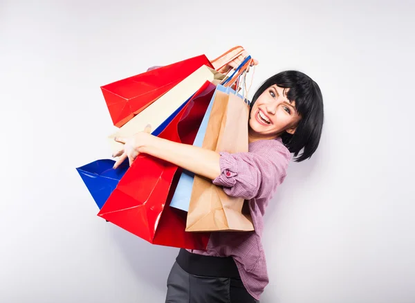 Jovem morena com sacos de compras — Fotografia de Stock