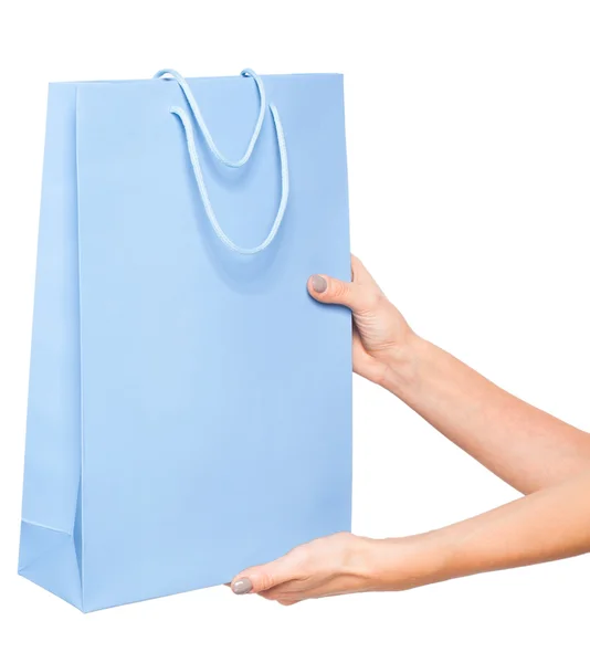 Manos sosteniendo bolsas de compras de colores sobre fondo blanco — Foto de Stock