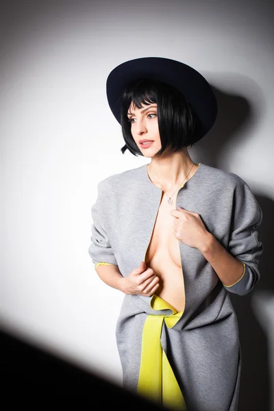 Modern woman with black hat on gray — Stock Photo, Image