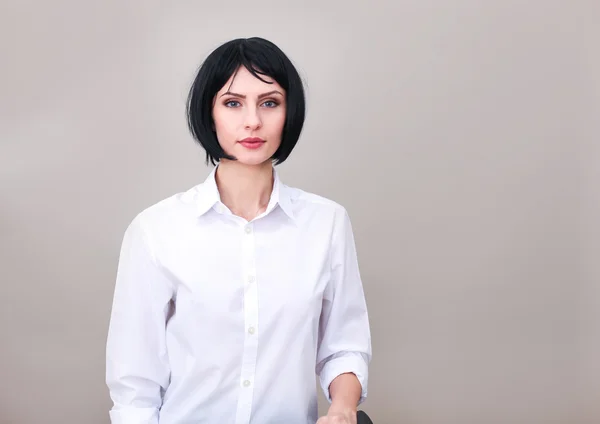 Brunette woman with blue eyes in white shirt isolated — Stock Photo, Image